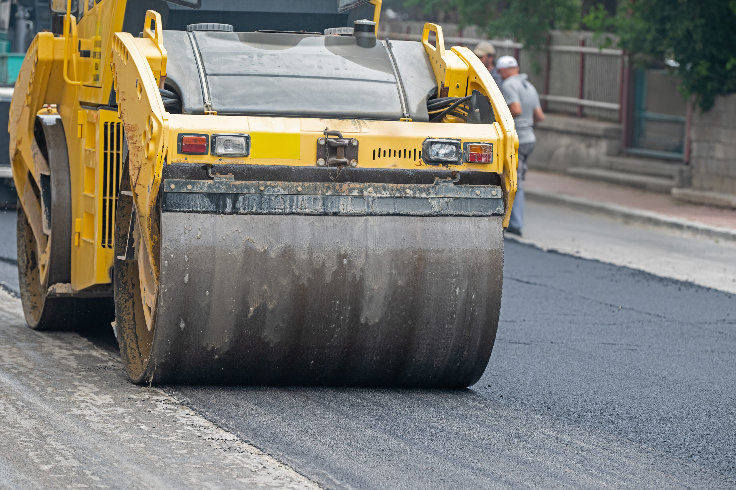 Operation of roller and asphalt paver machine during road construction and repair works.